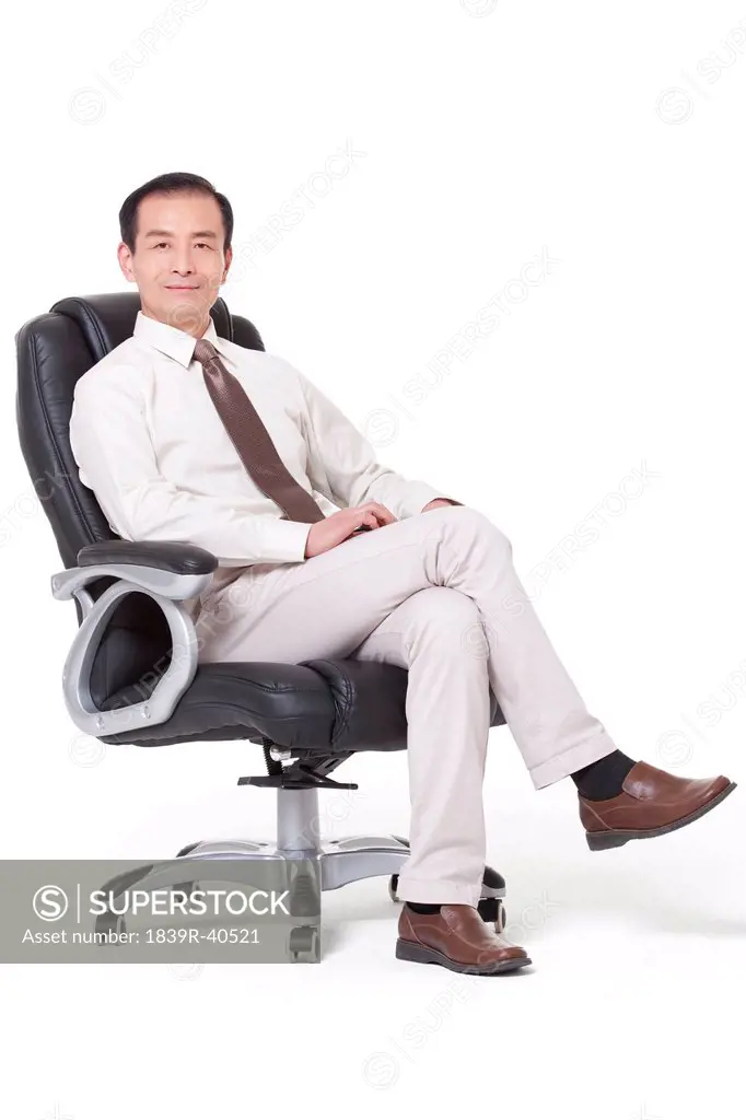 Senior businessman sitting in office chair