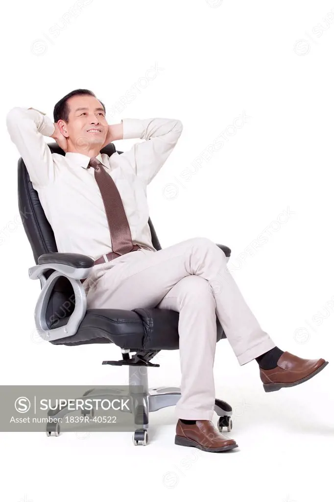 Senior businessman leaning back in office chair
