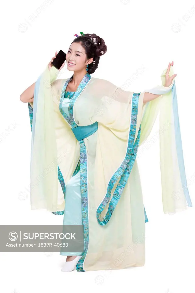 Young woman in Chinese traditional costume and smart phone