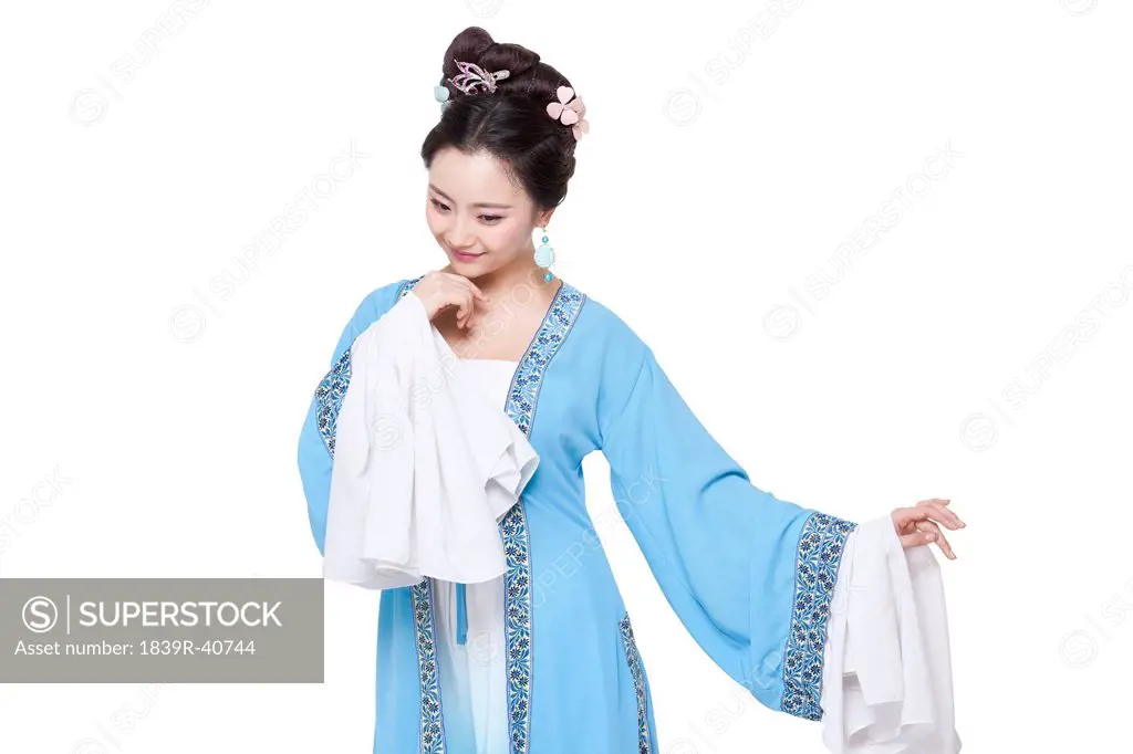 Young woman in Chinese traditional costume showing a shy look