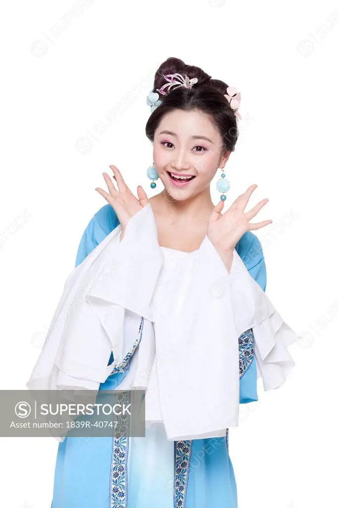 Young woman in Chinese traditional costume showing a surprise look