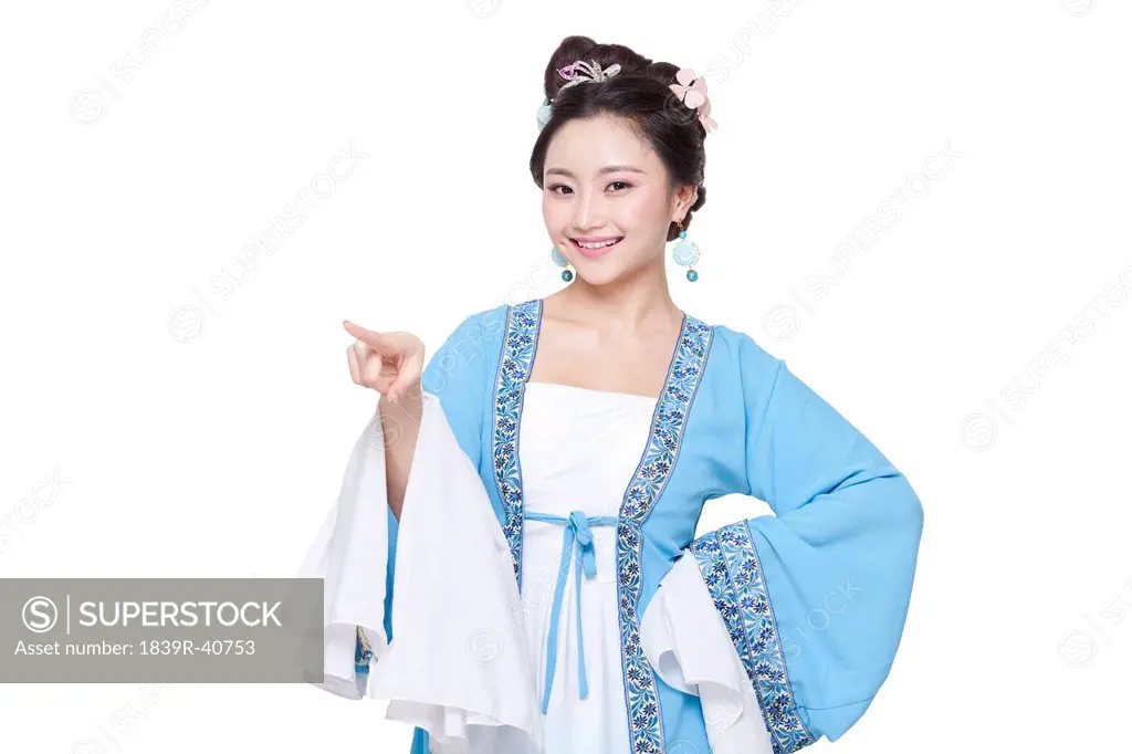 Young woman in Chinese traditional costume pointing forward