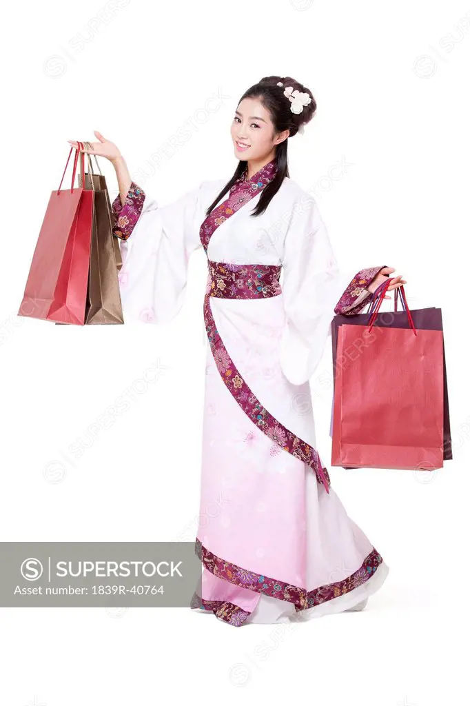 Young woman in traditional Chinese costume with shopping bags