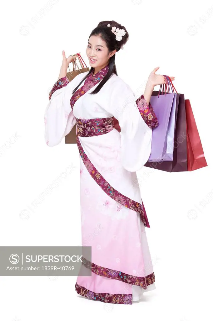 Young woman in traditional Chinese costume with shopping bags