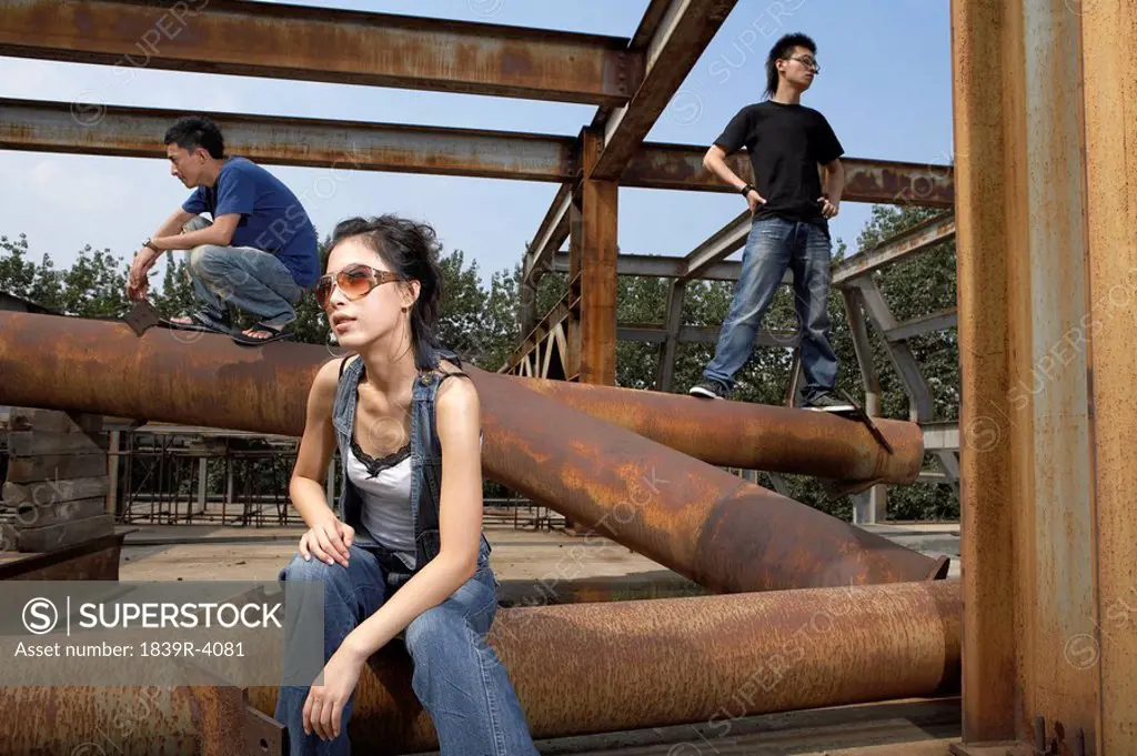 Young People Standing On Pipes