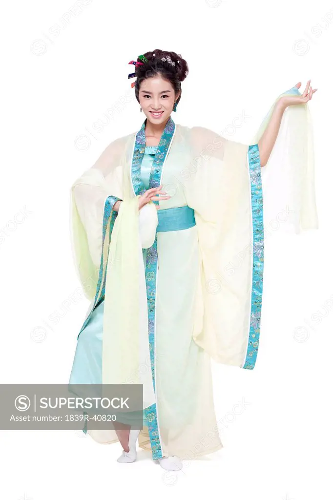 Young woman in traditional Chinese costume performing traditional dancing