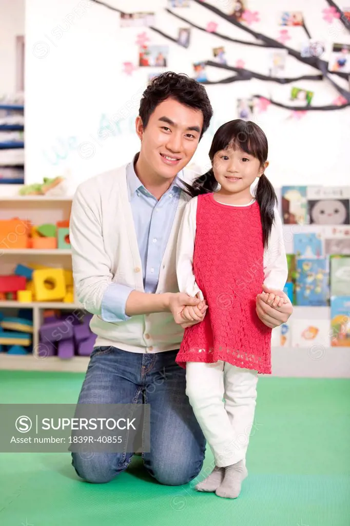 Male teacher and cute little girl