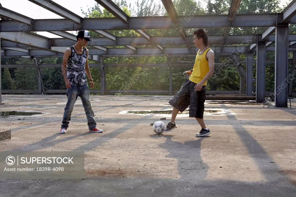 Men Kicking Soccer Ball