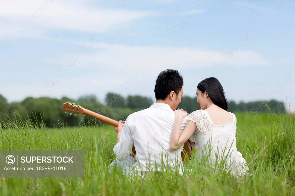 Young couple enjoying music outdoors