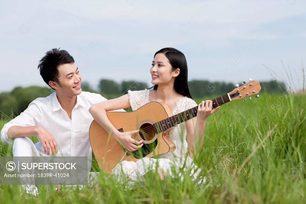 Young couple enjoying music outdoors