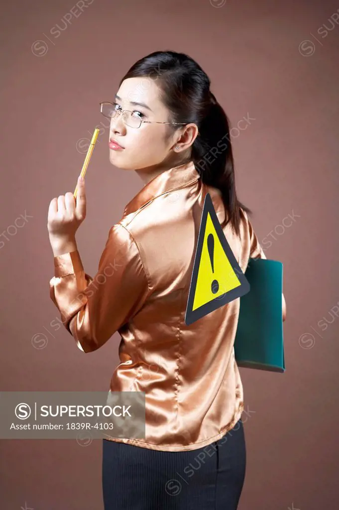 Young Woman With A Road Sign On Her Back