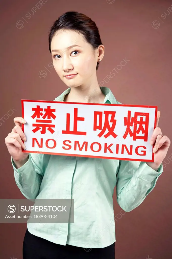 Young Woman Holding A No Smoking Sign