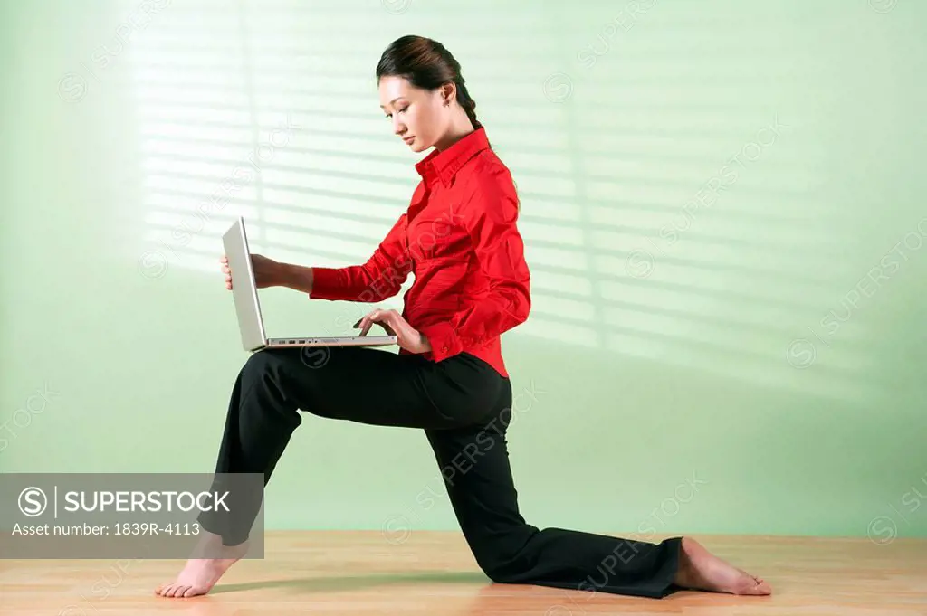 Woman With Laptop Computer On Her Knee