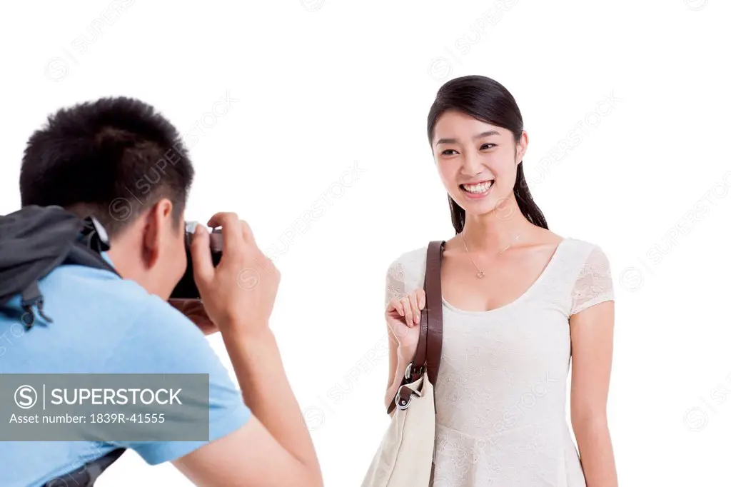 Man taking pictures of smiling wife