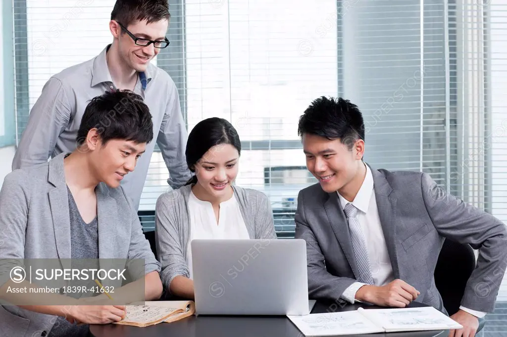 Young office workers using laptop