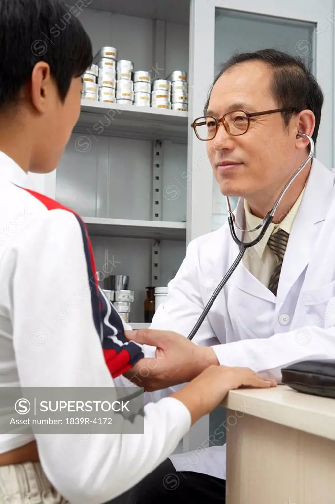 Doctor Listening To Patient´s Heart With Stethoscope