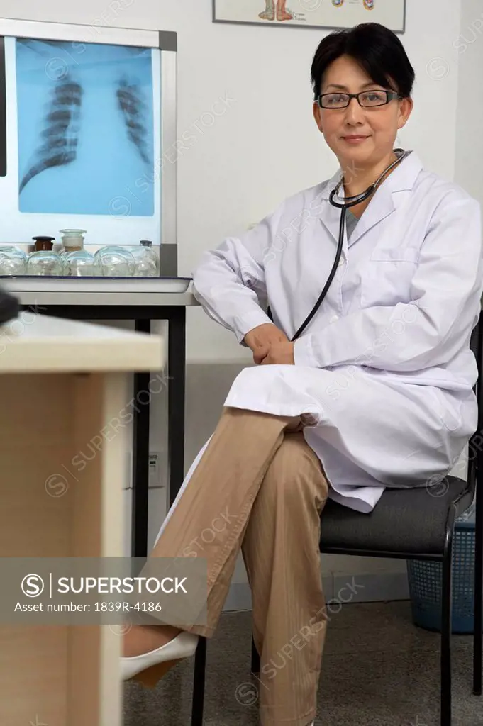 Doctor Sitting At Desk