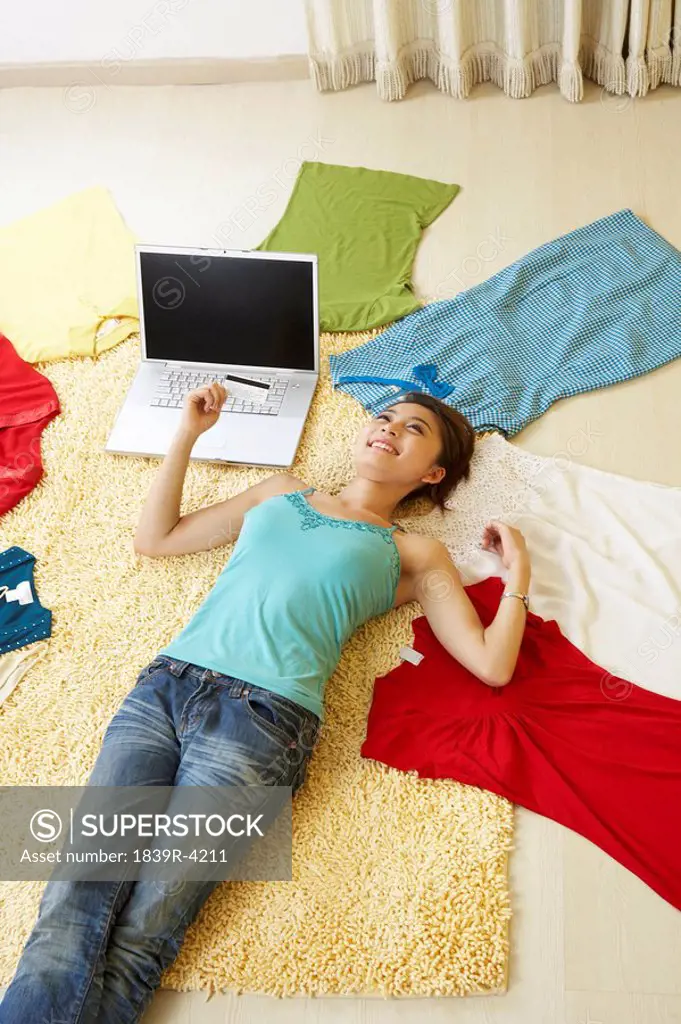 Young Woman Laying On The Floor With Clothes