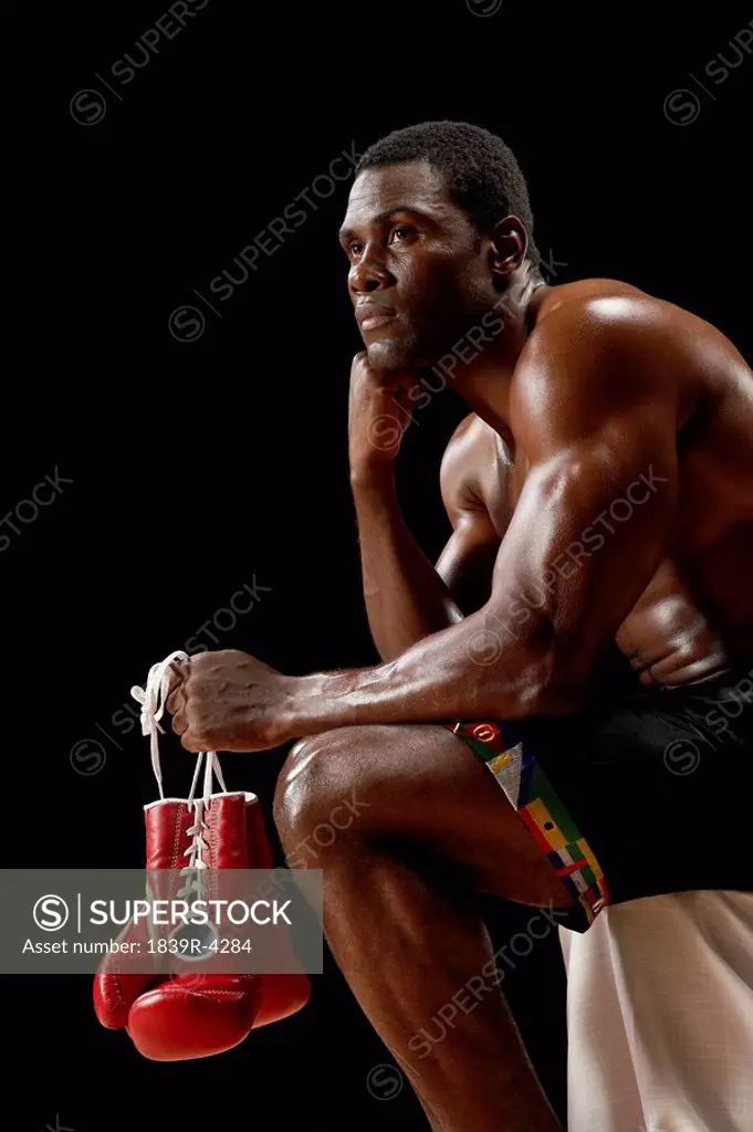 Boxer Sitting Holding Gloves