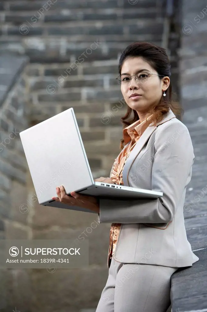 Businesswoman Holding Laptop Computer