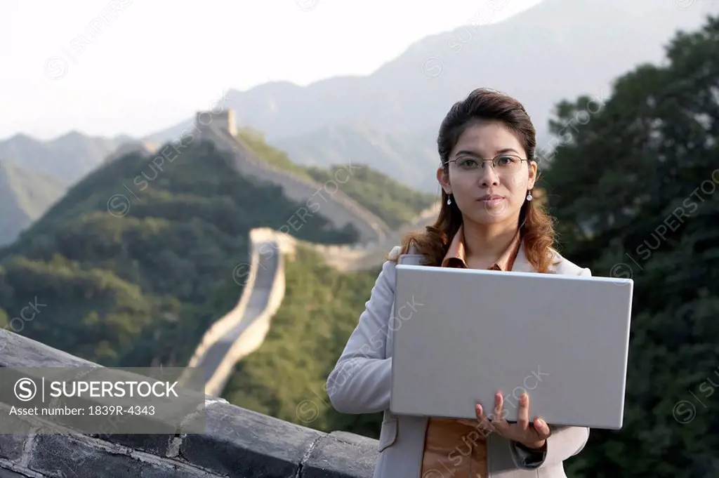 Businesswoman Typing On Laptop Computer, On The Great Wall Of China