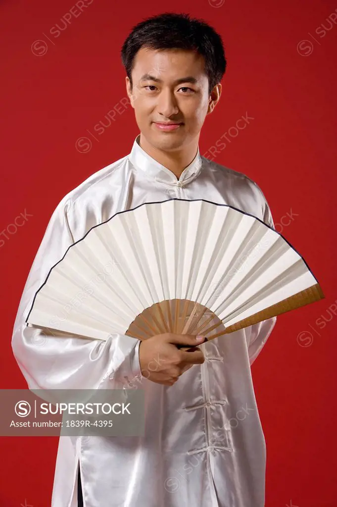 Man With Fan Looking At Camera