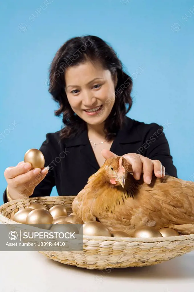 Businesswoman With Chicken And Golden Eggs