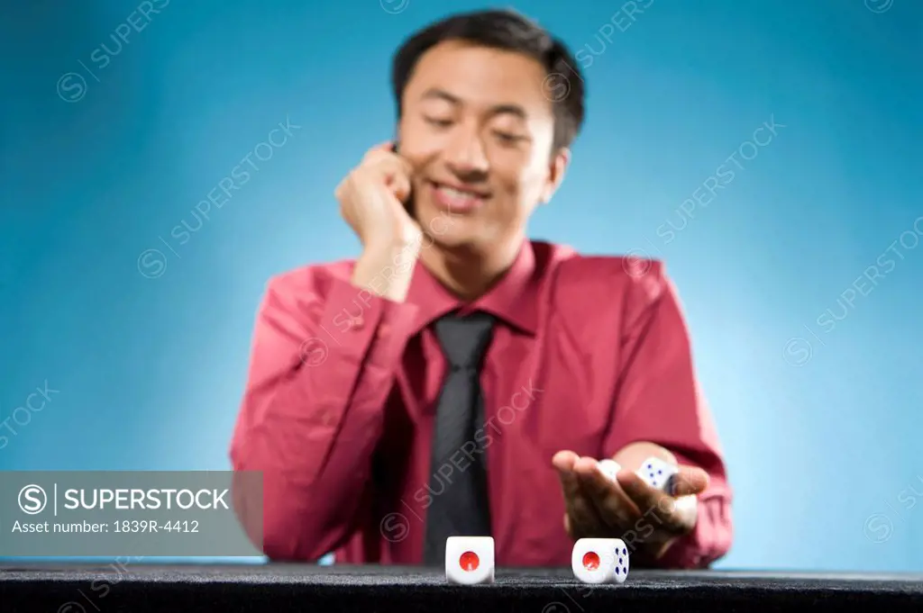 Businessman Playing With Dice