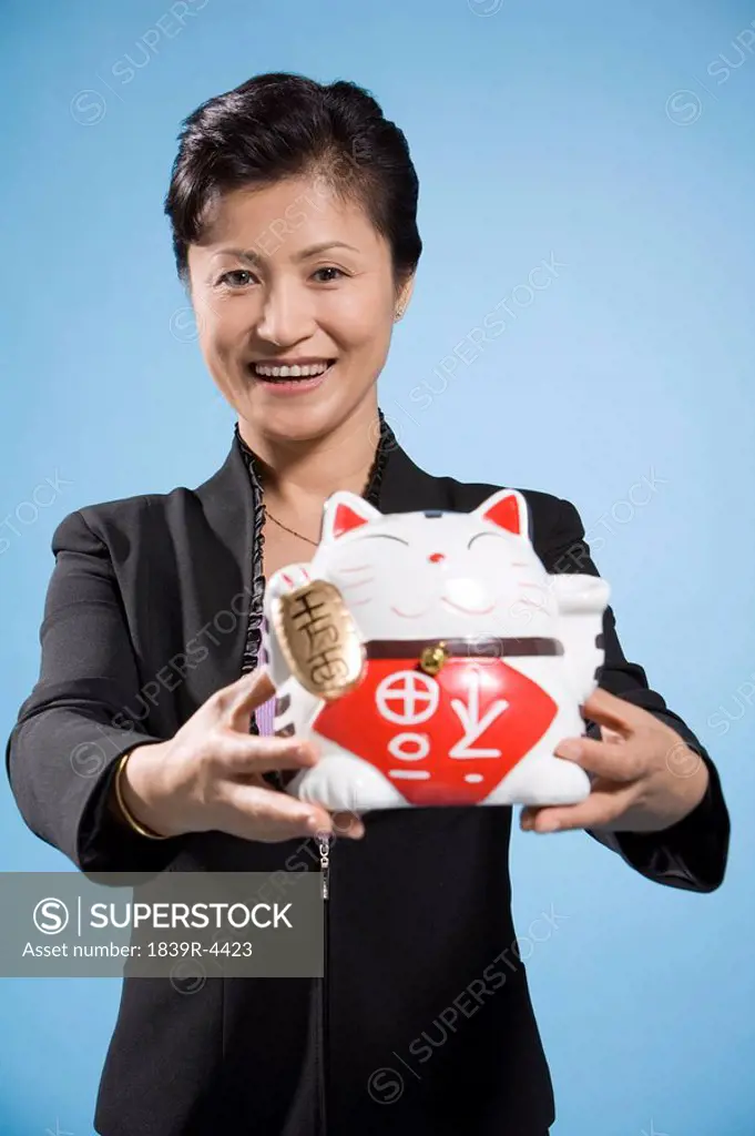 Businesswoman Holding Maneki Neko, A Lucky Cat Charm