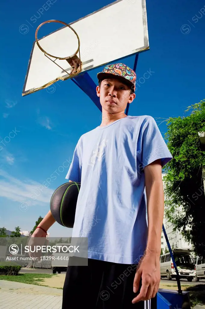 Teenage Boy With Basketball In Park