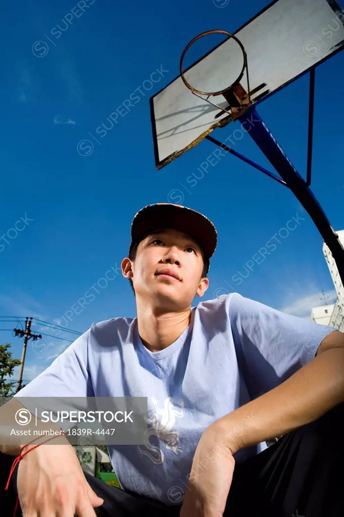 Teenage Boy Crouching On Basketball Court