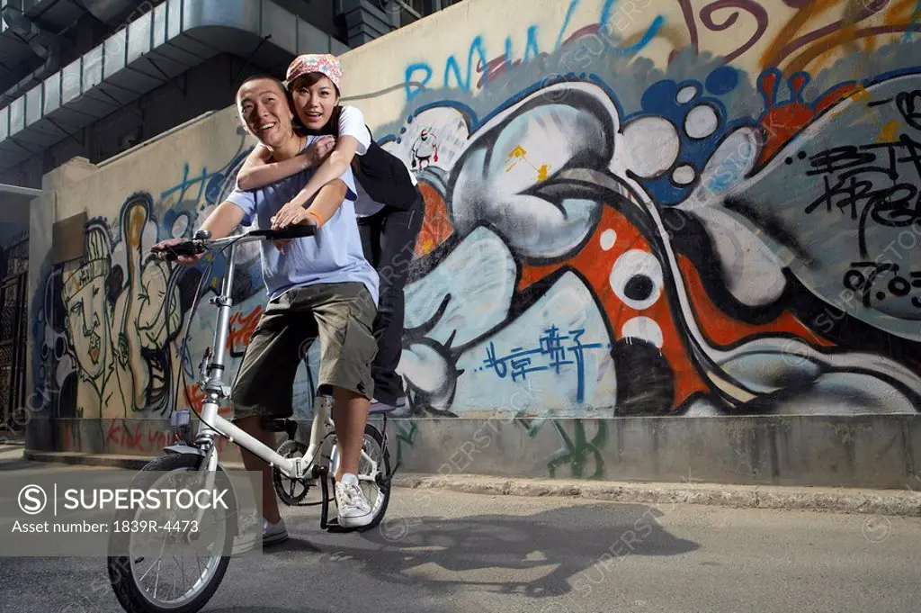 Teenage Girl And Boy On A Bike