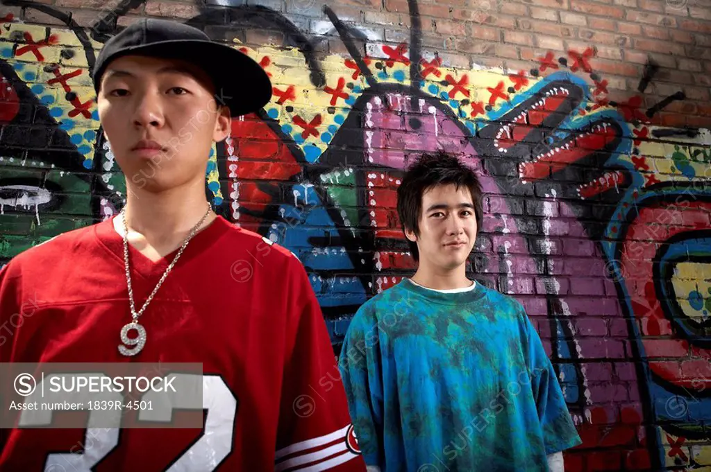 Teenage Boys In Front Of A Wall Of Graffiti