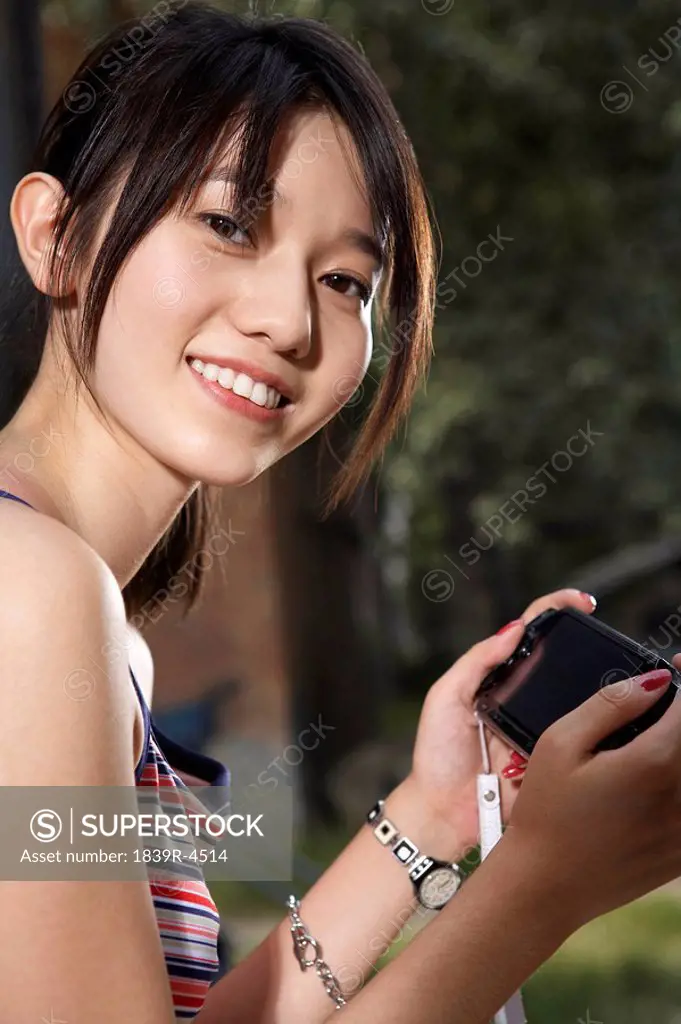 Teenage Girl With Personal Game Console