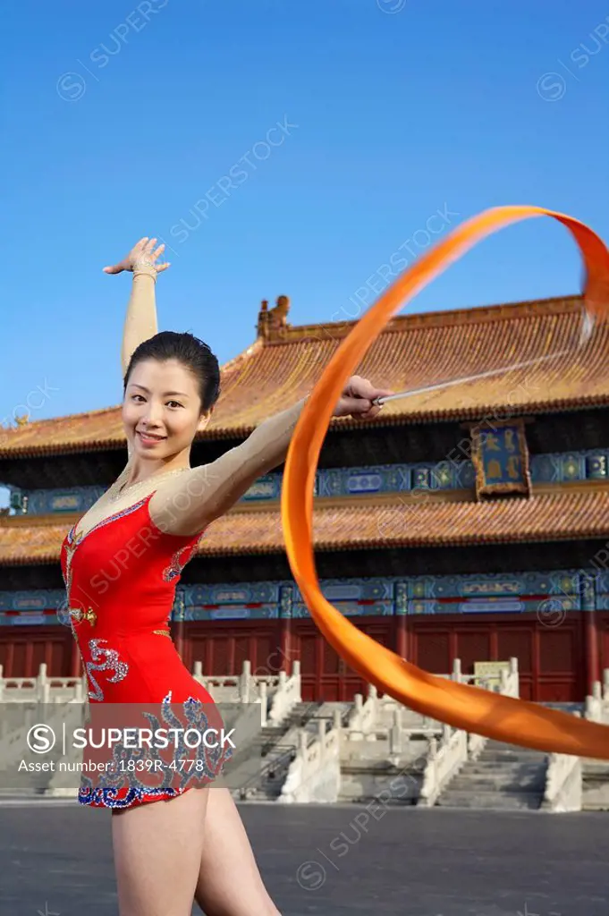 Young Woman Ribbon Dancing In Front Of A Temple