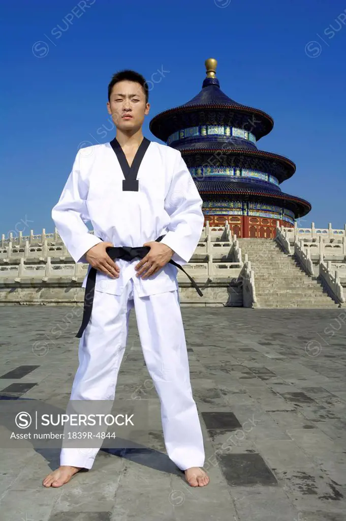 Portrait Of Young Male Martial Artist In Front Of Temple
