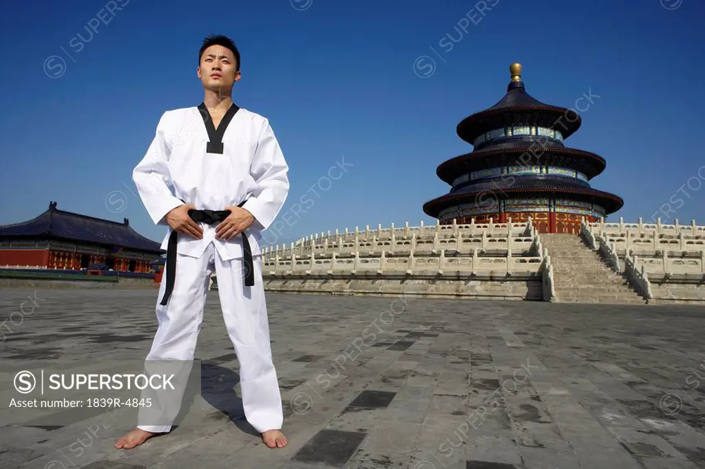 Portrait Of Young Male Martial Artist In Front Of Temple