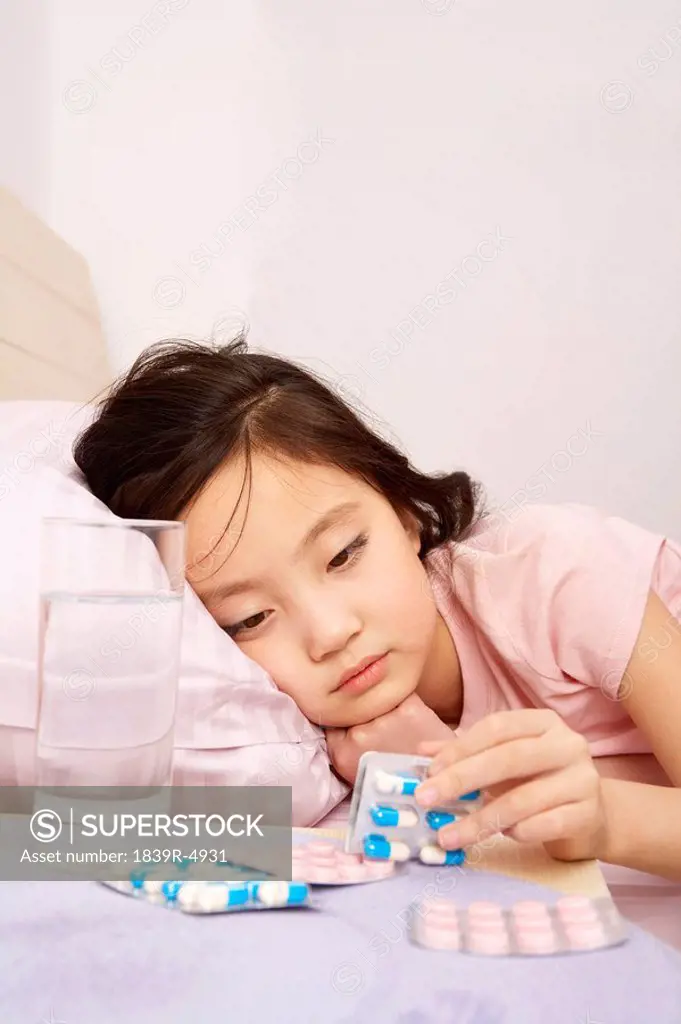 Girl Looking At Cold And Flu Pills