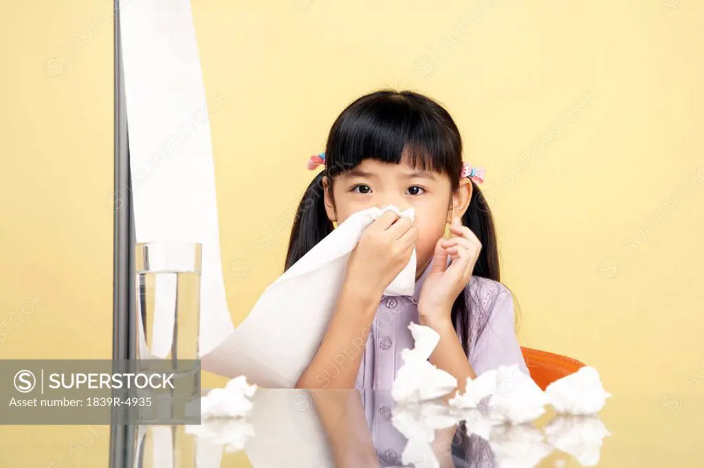 Girl Blowing Her Nose On Tissues