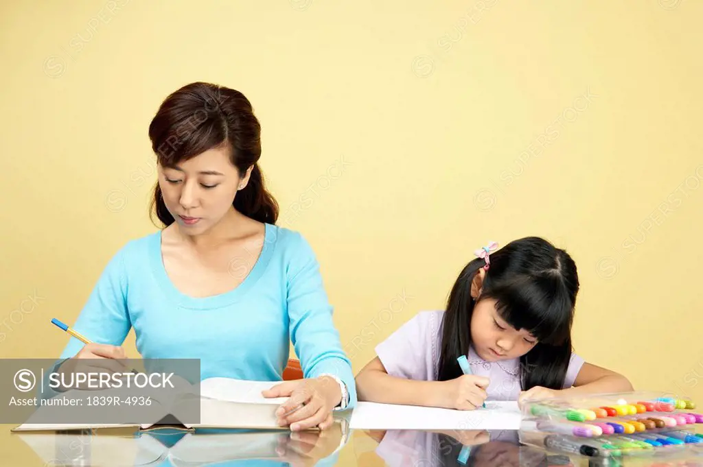 Mother And Daughter Learning And Coloring