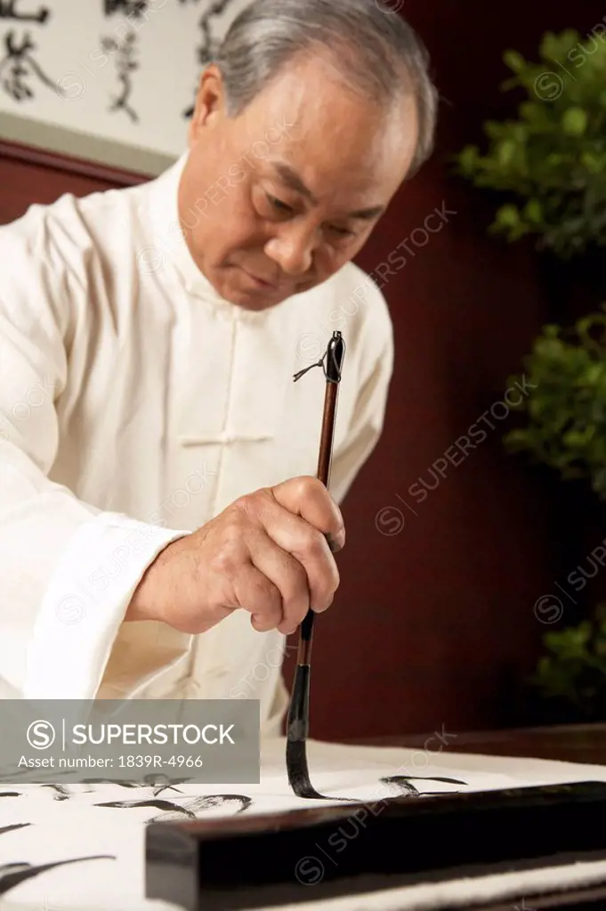 Elderly Man Practicing Calligraphy