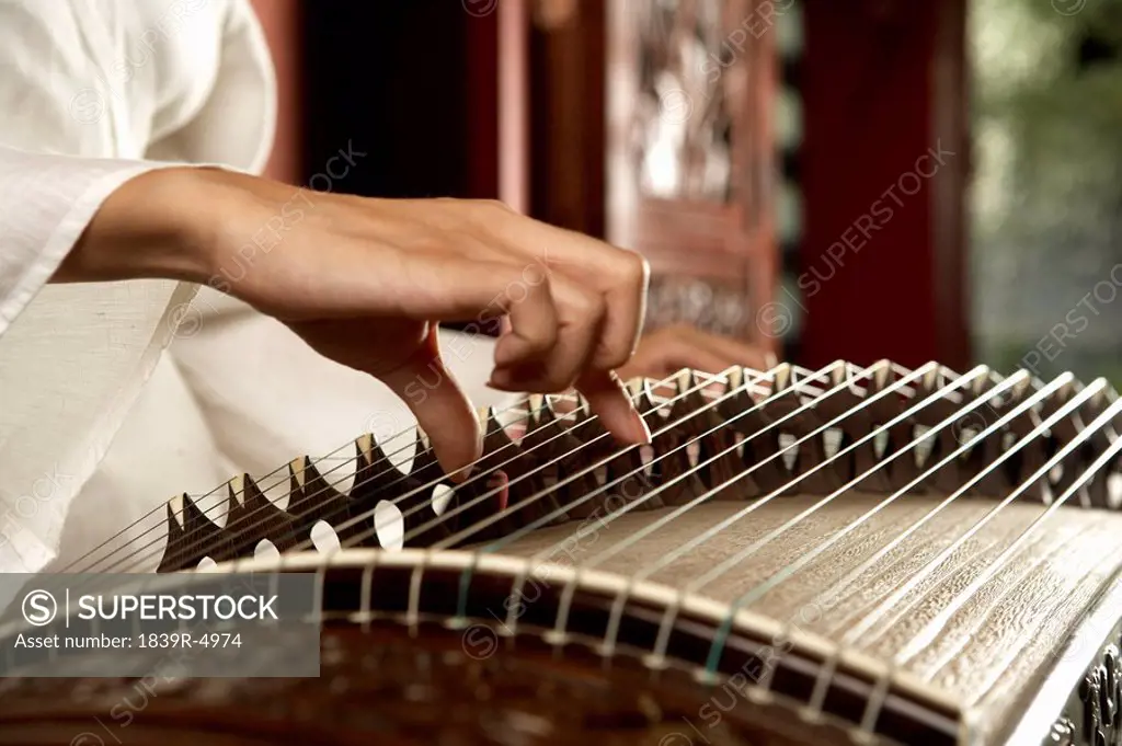 Young Woman Playing Traditional Chinese Instrument