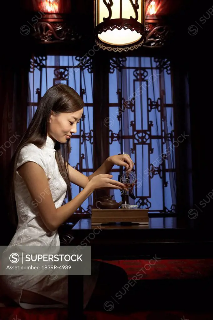 Young Woman Performing Traditional Tea Ceremony
