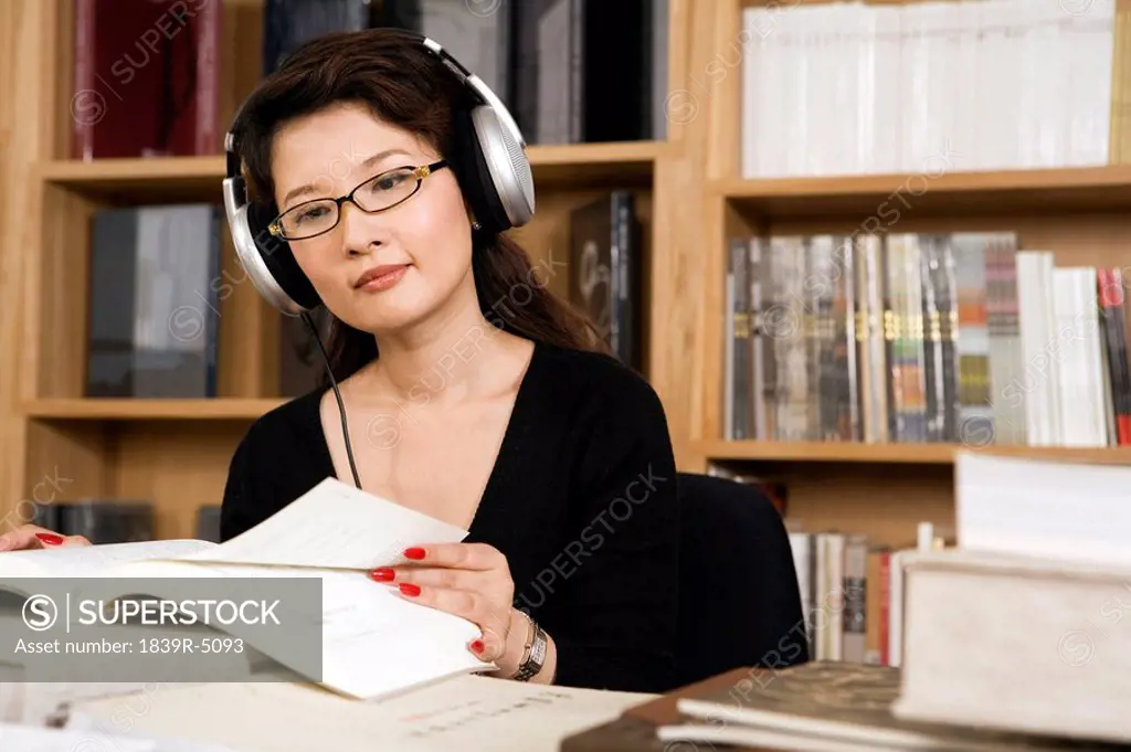 Woman Wearing Headphones While Studying