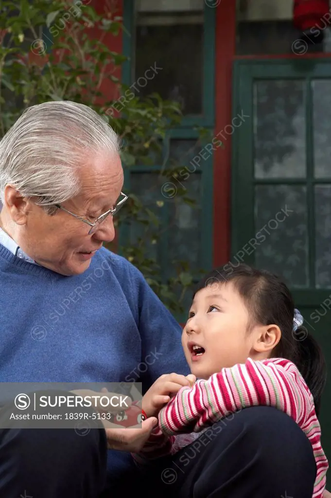 Grandfather And Daughter Looking At Each Other