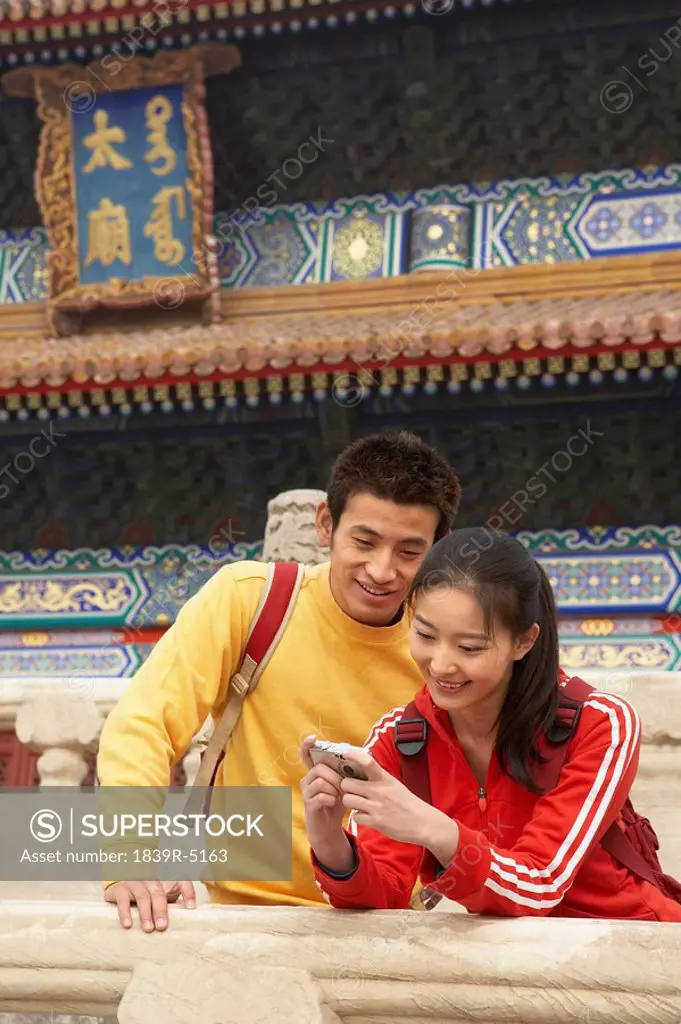 Young Couple Visiting The Forbidden City, Beijing, China
