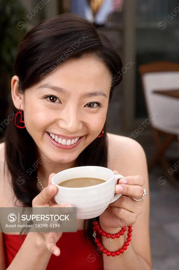 Young Woman Drinking Cup Of Tea