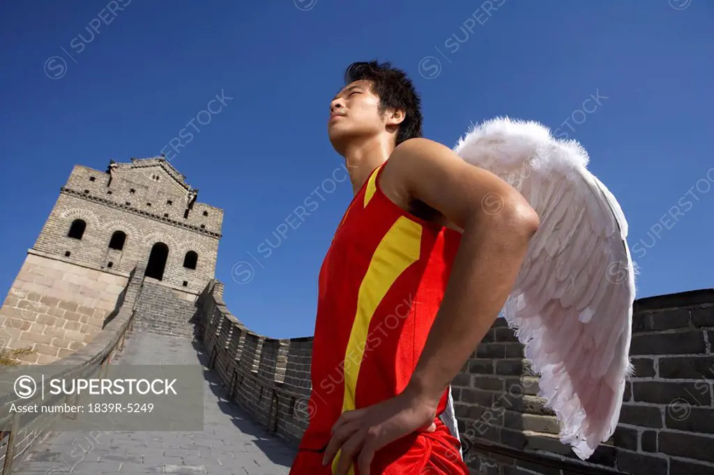 Athlete With Angel Wings Standing Proudly On The Great Wall Of China