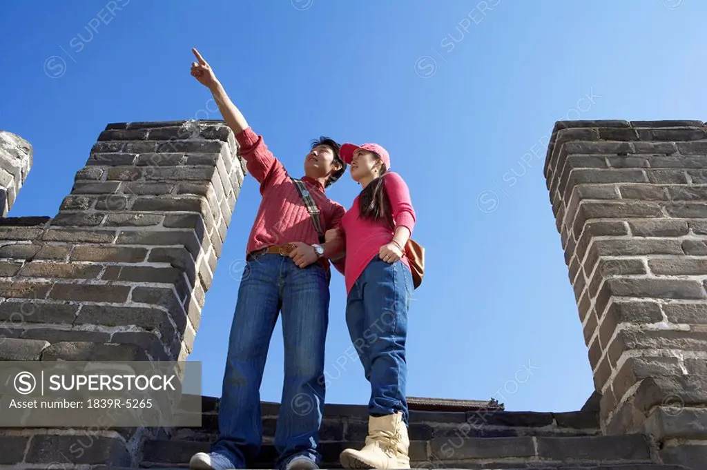 Young Couple Visiting The Great Wall Of China
