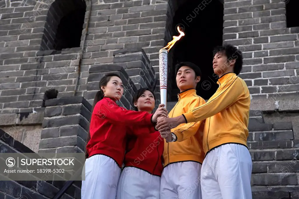 Two Young Couples Perform The Passing Of The Torch Ceremony At The UNESCO World Heritage Site